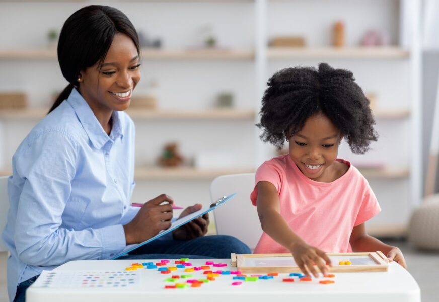 Smiling,Child,Development,Specialist,Young,African,American,Woman,Esting,Cute